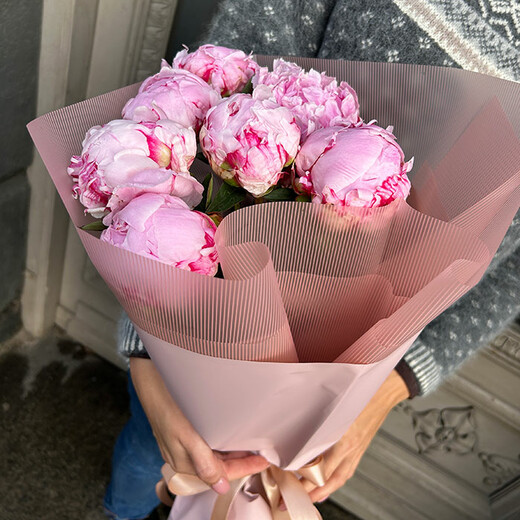 Pink peonies in decorative packaging