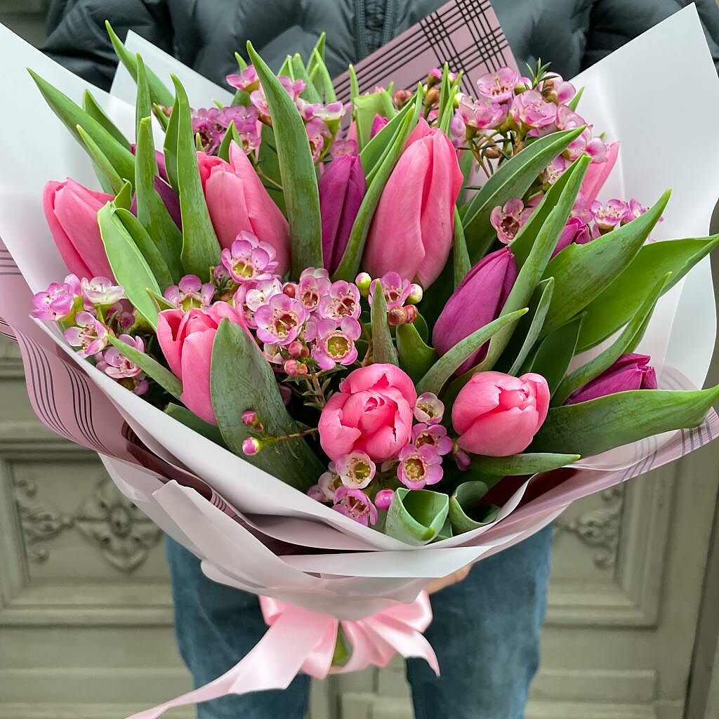 Bouquet of tulips with a wax flower in a decorative package
