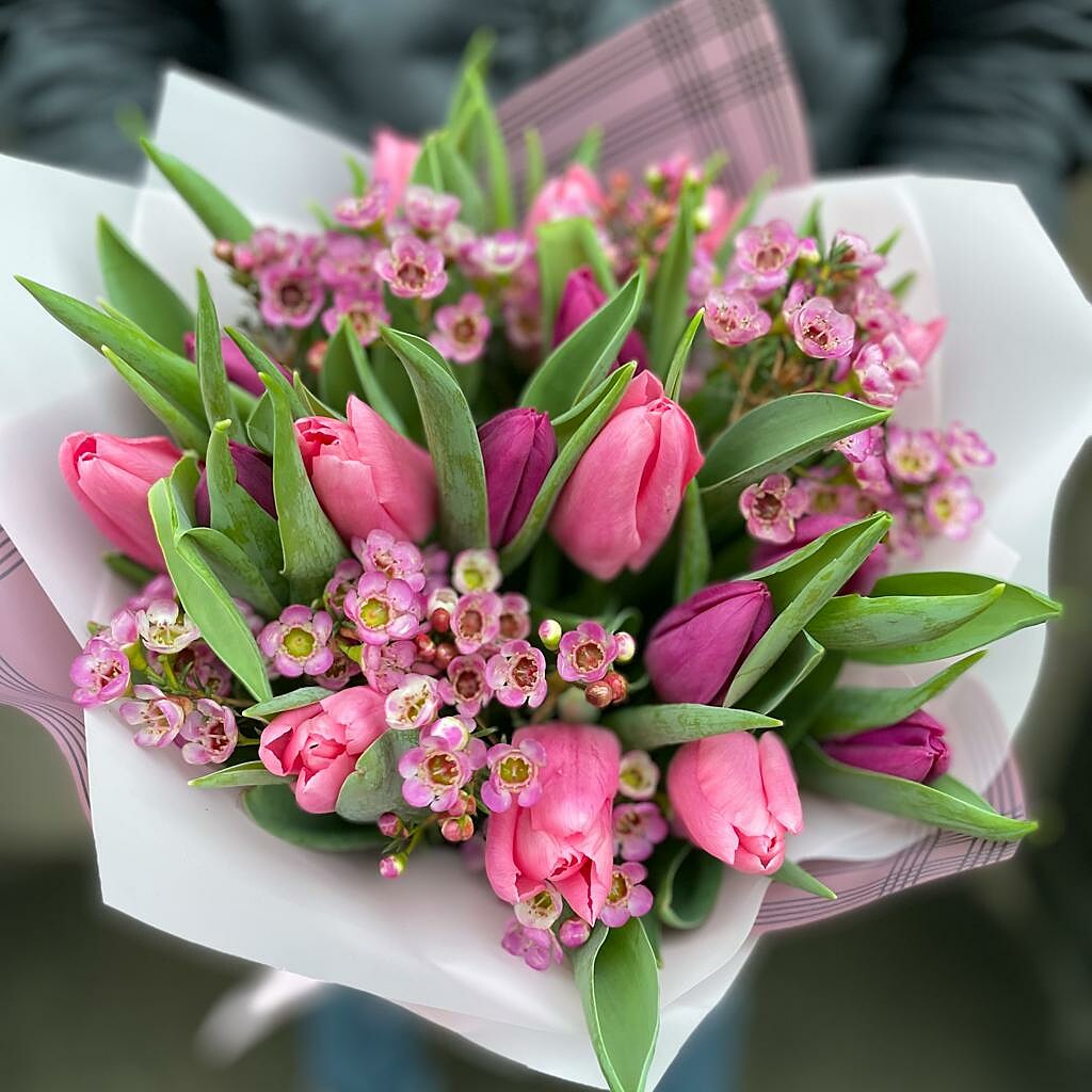 Bouquet of tulips with a wax flower in a decorative package