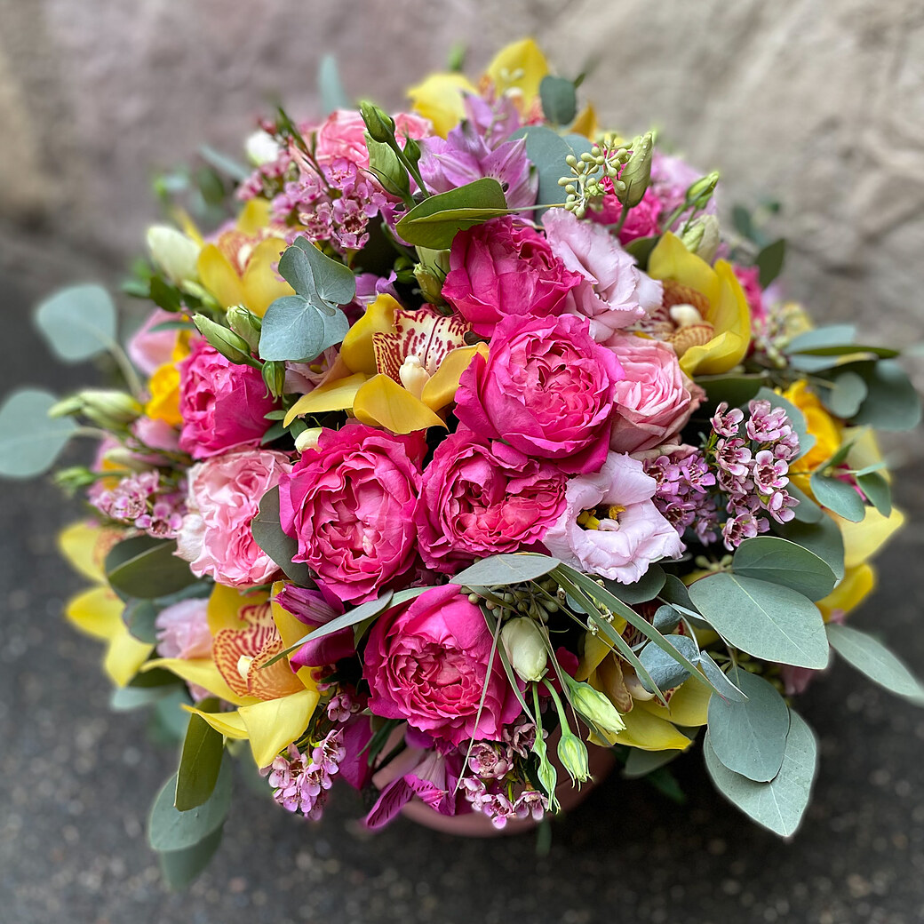 Bright composition of exotic flowers in a box