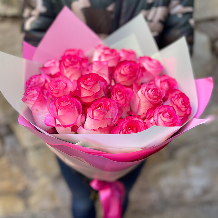 Dark pink roses in decorative packaging