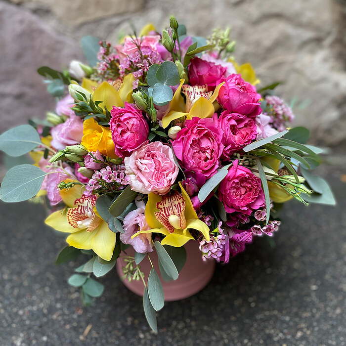 Bright composition of exotic flowers in a box