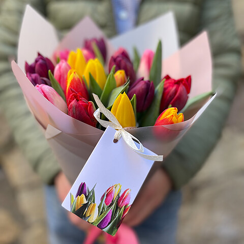 Tulips of different colors in decorative paper