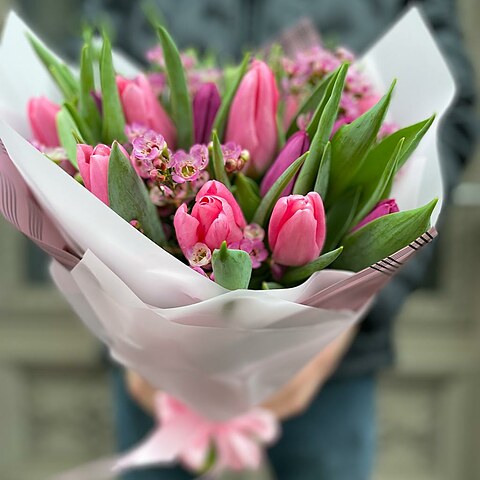 Bouquet of tulips with a wax flower in a decorative package